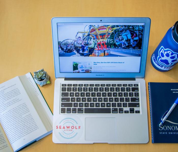 Computer, notebook, water bottle 